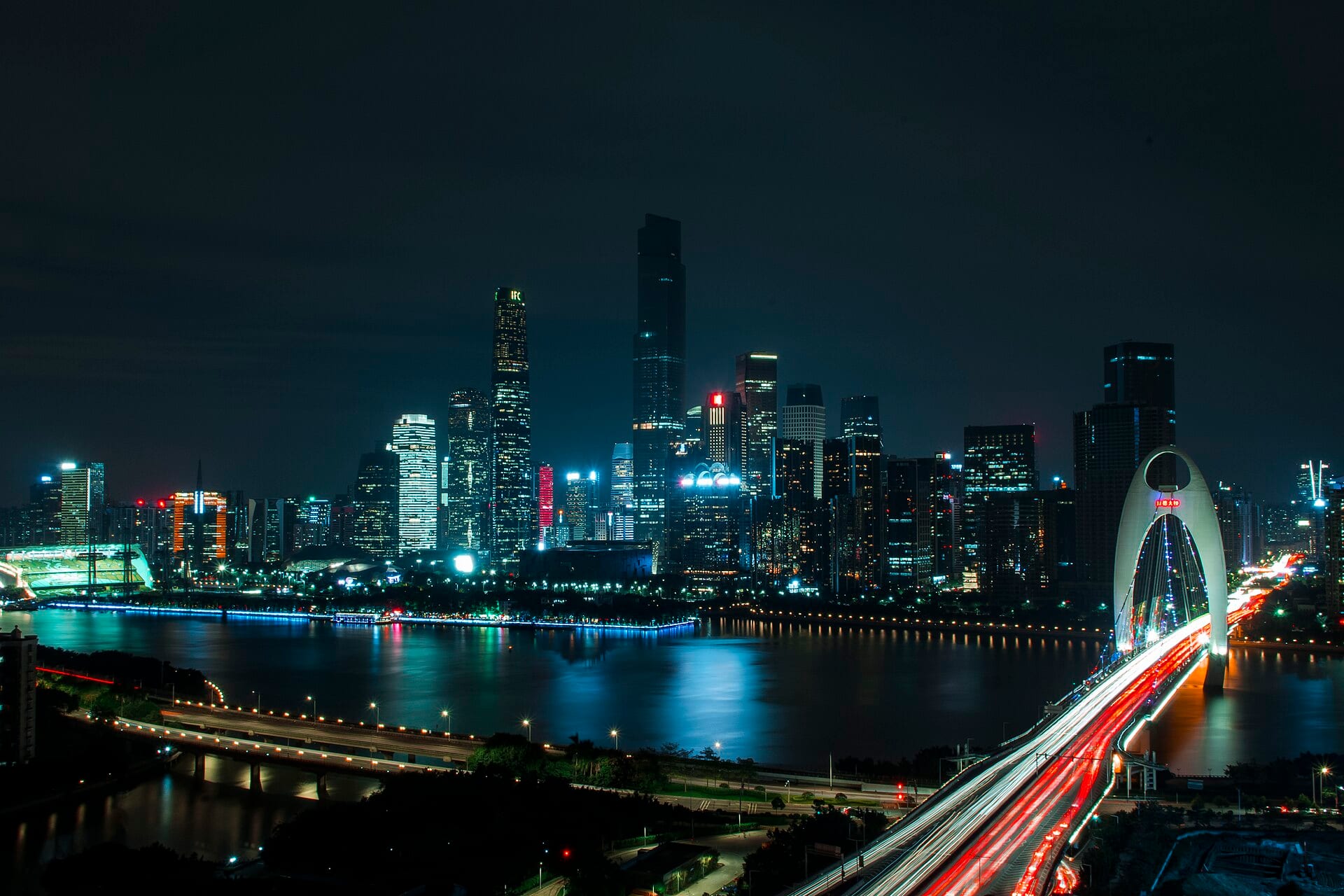 The Guangzhou skyline at night, seen across the Pearl river with the Liede bridge to the right.